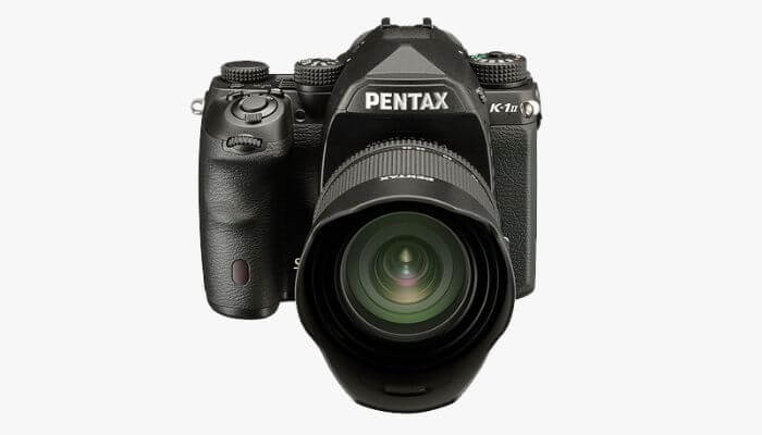 Pentax DSLR camera body with lens.