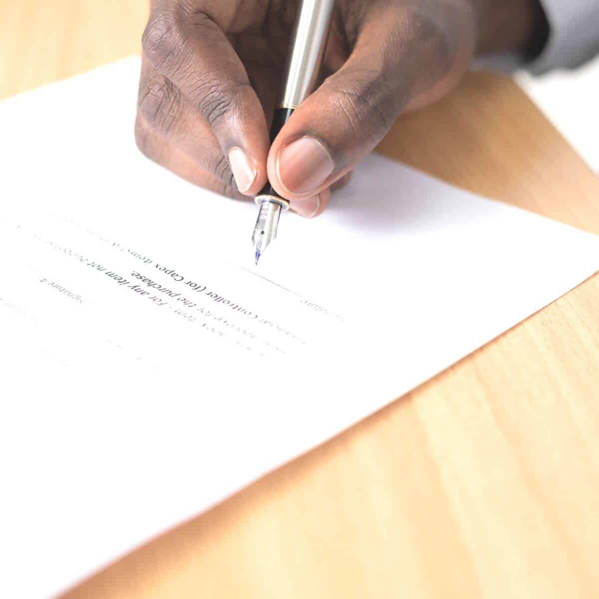Person signing a contract.