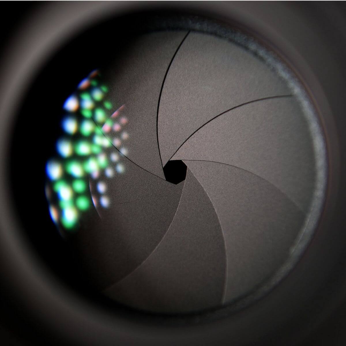 Close-up of a camera lens showing the aperture.