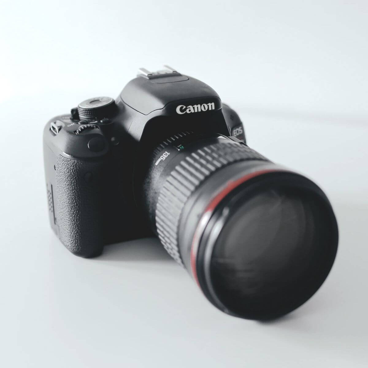 Canon camera on a white table.