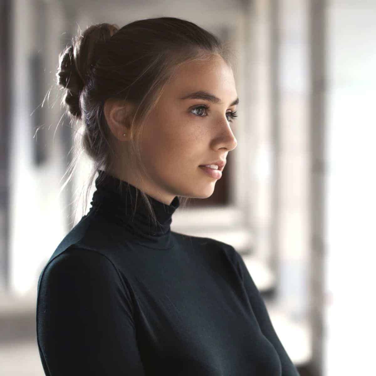 Person wearing a turtleneck and facing the side.