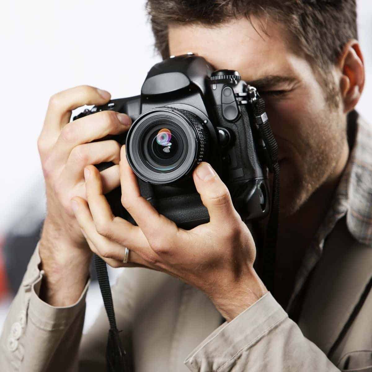 Close-up of a photographer taking a photo.