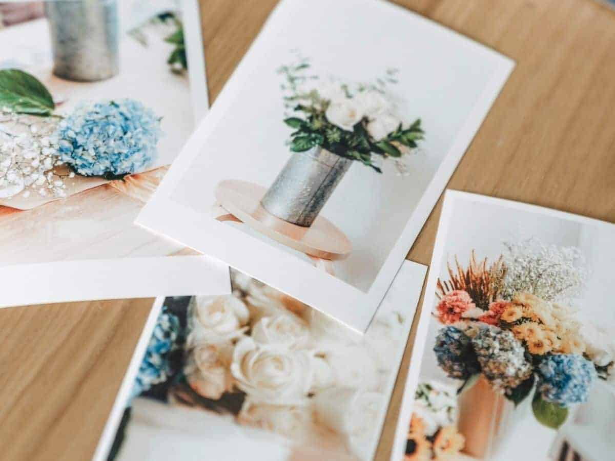 Printed photos with a matte finish on a table.