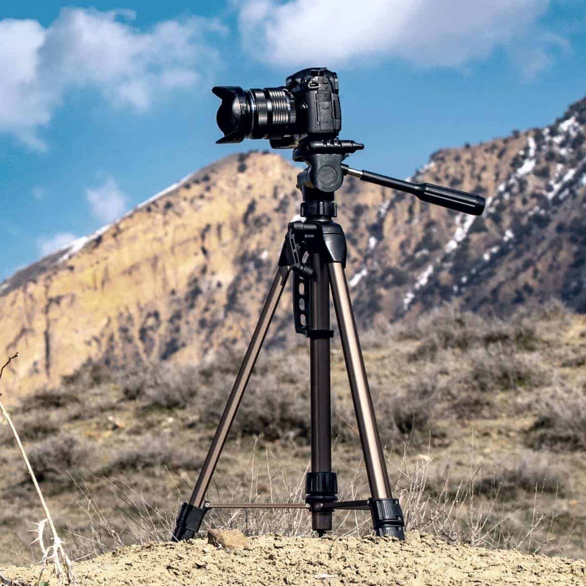 Camera on a tripod in the mountains.