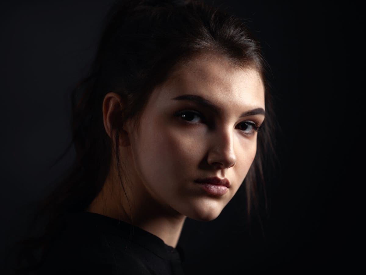 Headshot of a woman using Rembrandt lighting.