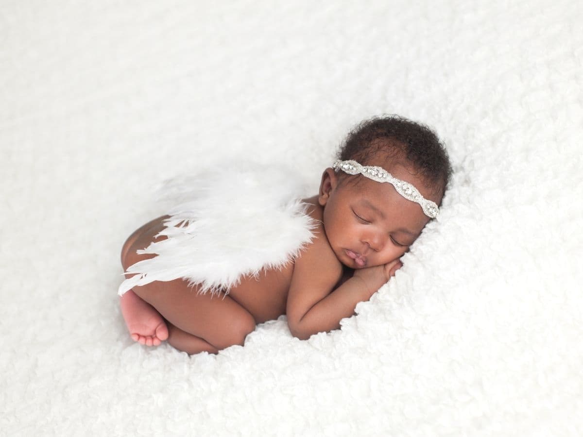 Newborn baby with angel wings.