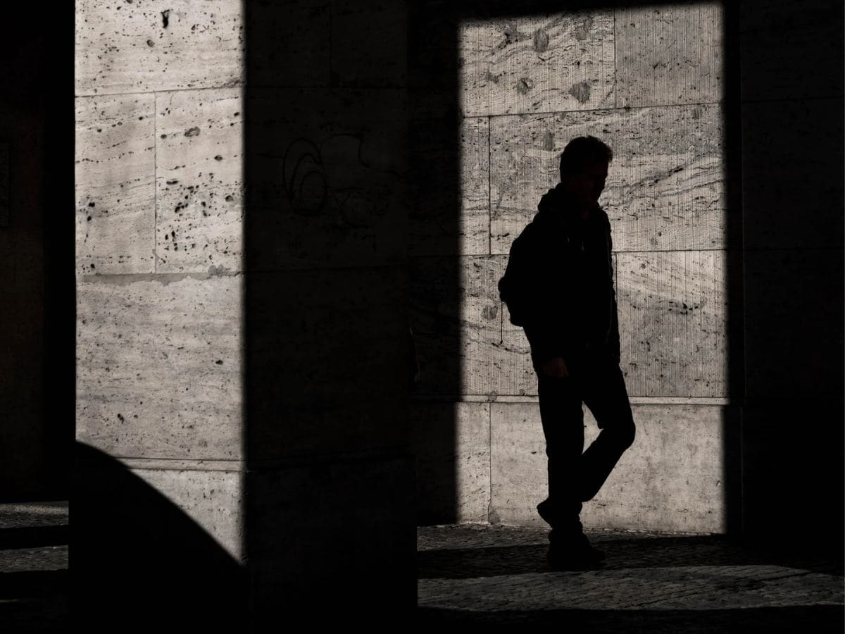 Silhouette of a person framed by shadows.