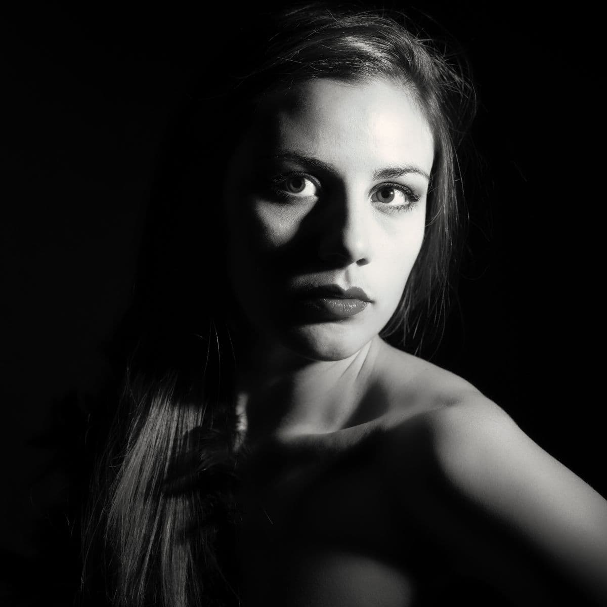 Greyscale portrait of a woman with Rembrandt lighting.