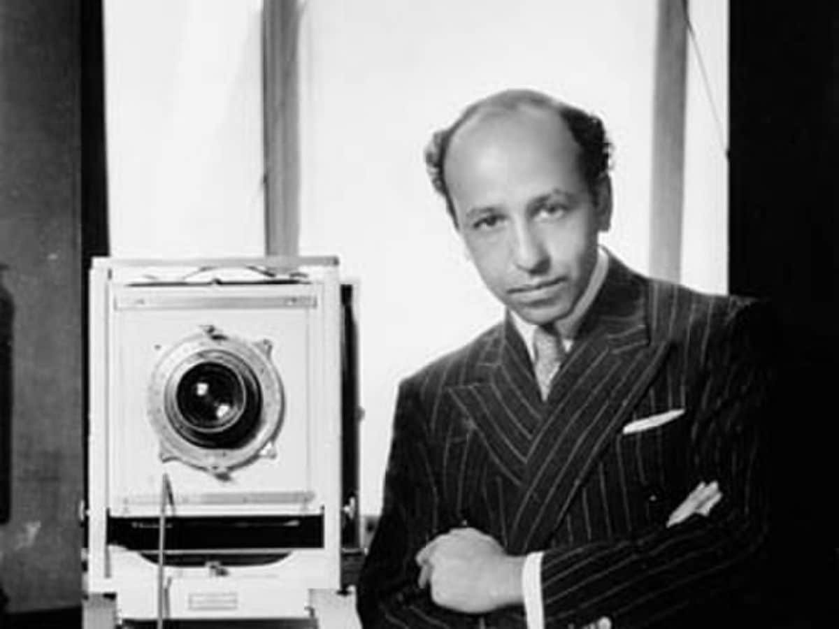 Yousuf Karsh next to a camera.