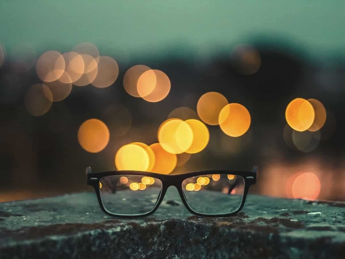 Glasses on a ledge with bokeh in the background.