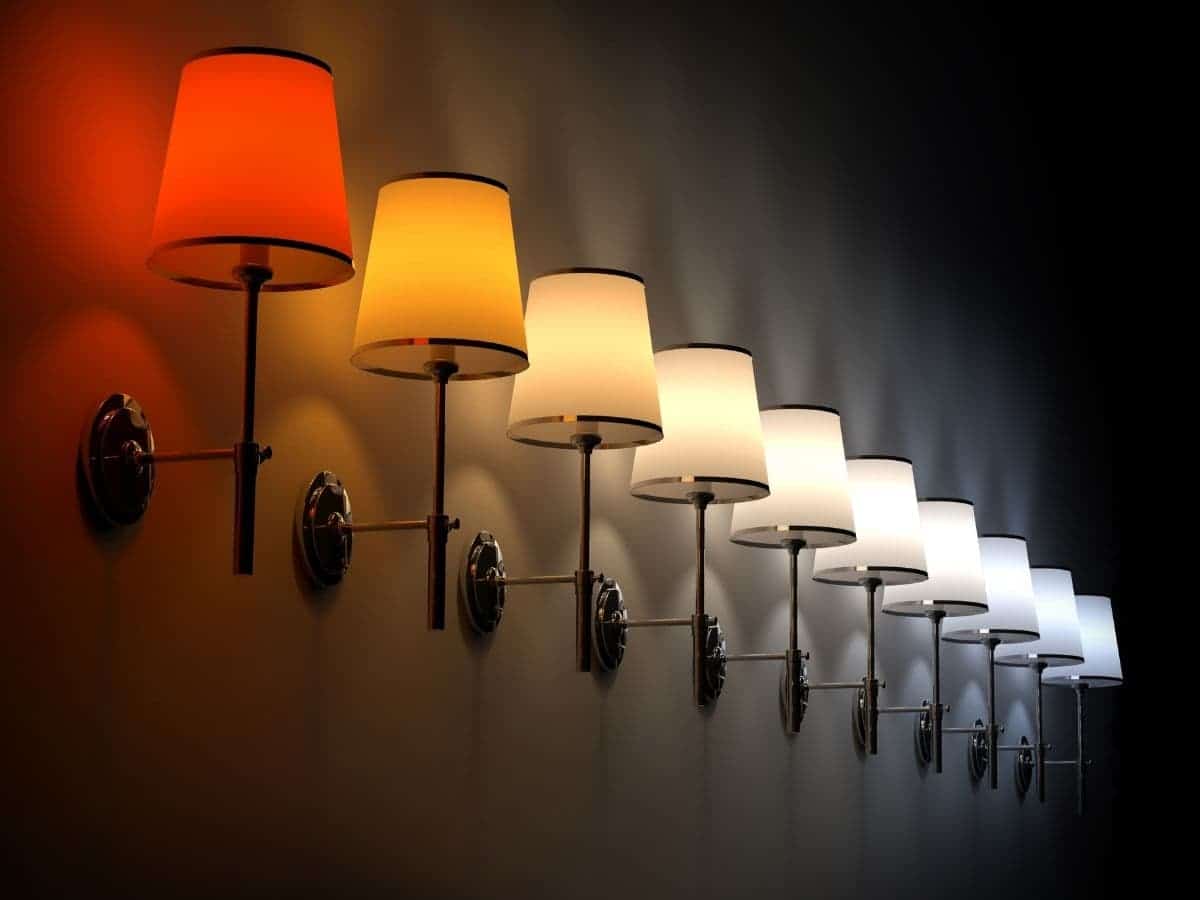Lamps mounted on a wall with different color temperatures.