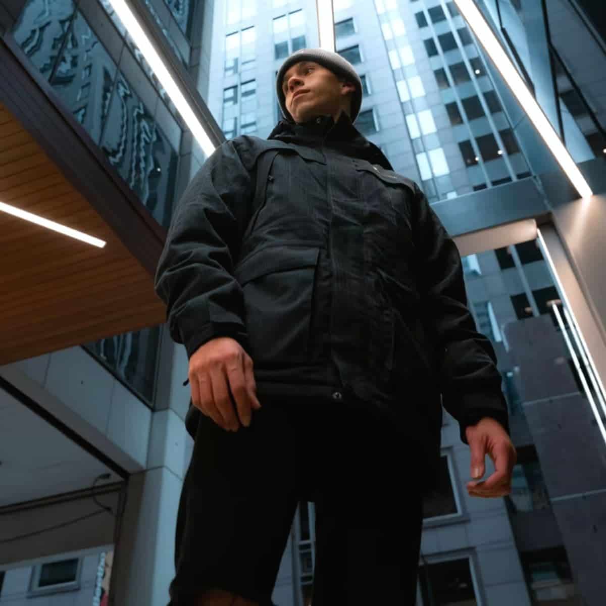 Low-angle shot of a person surrounded by tall buildings.