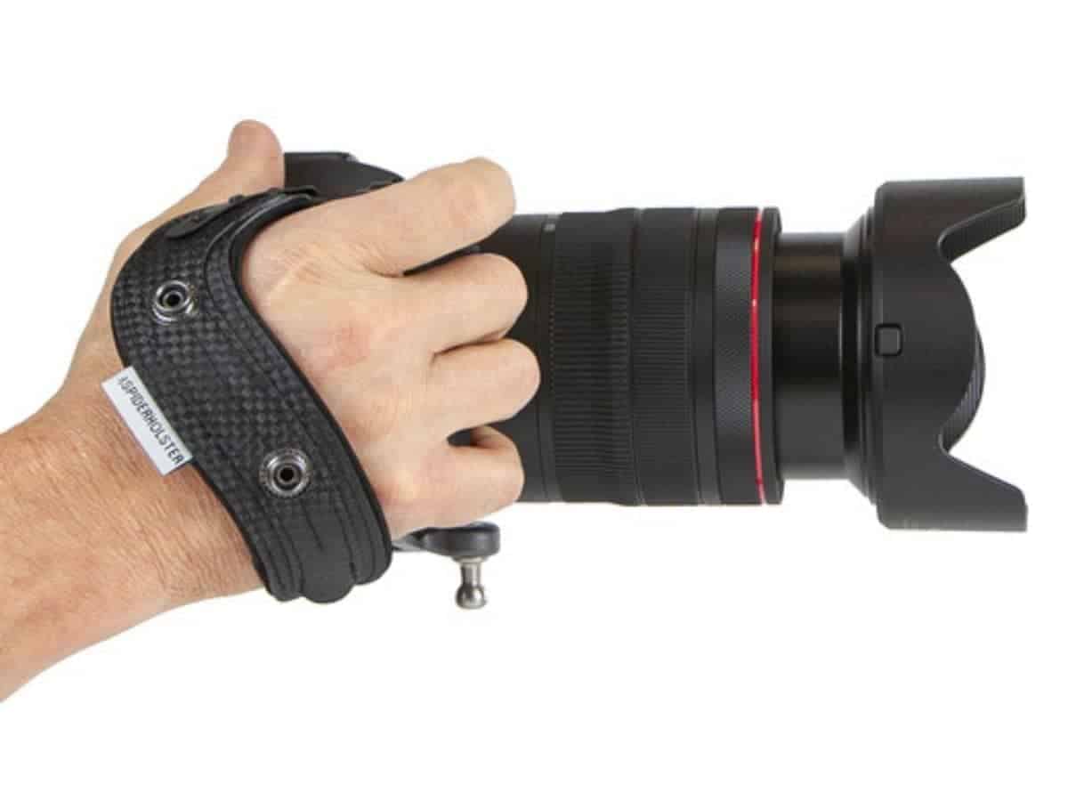 Person using a SpiderPro camera hand strap.