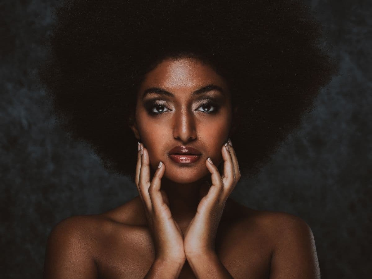 Person with an afro using butterfly lighting.