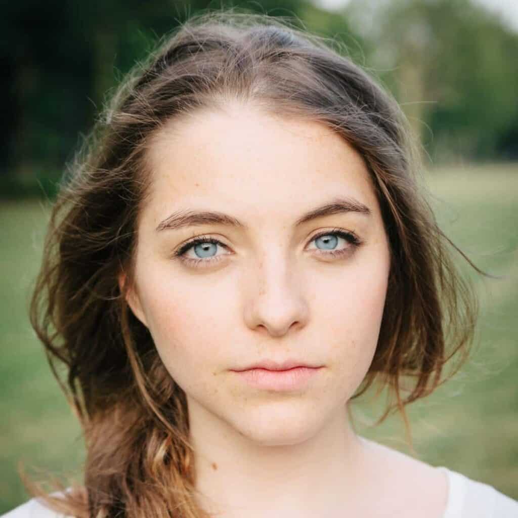 Headshot of a person outdoors with flat lighting.