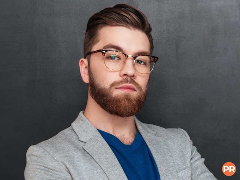 Headshot of a person with glasses and a beard.