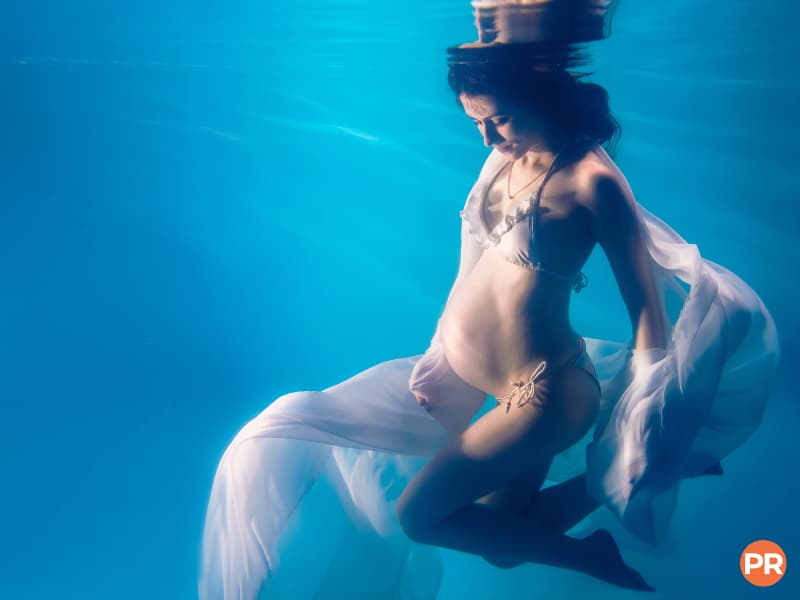Pregnant woman underwater.