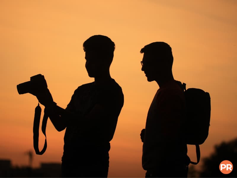 Silhouette of two photographers during a sunset.