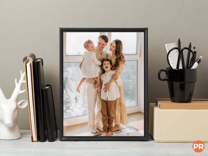 Framed photo of a family on a desk.