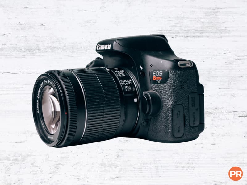 Canon DSLR camera with a lens.