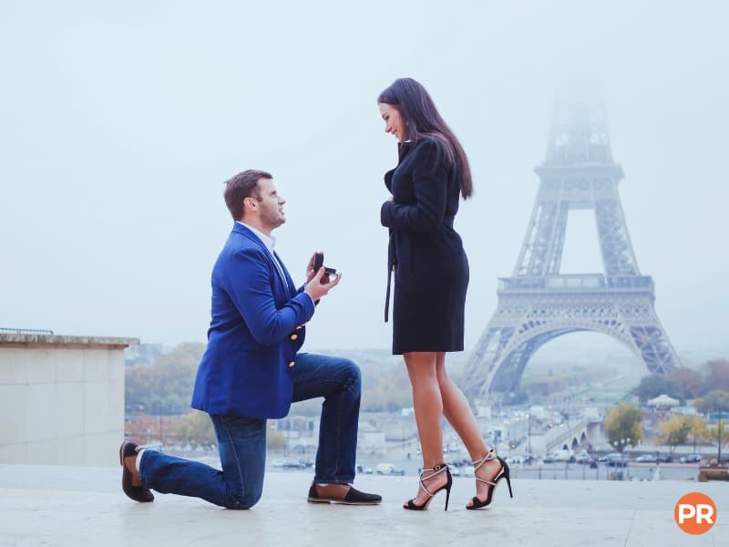 Couple getting engaged in front of the Eiffel Tower.